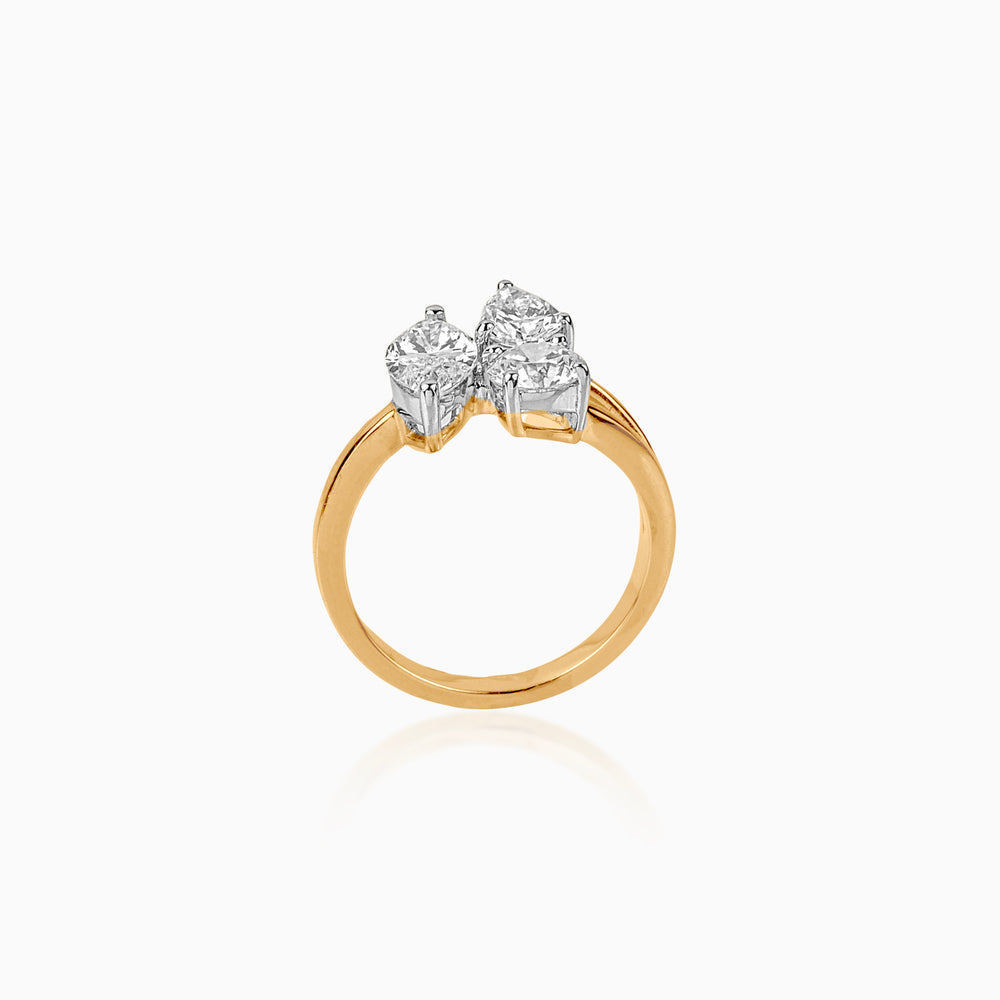 Gold ring with three brilliant-cut diamonds in white metal setting