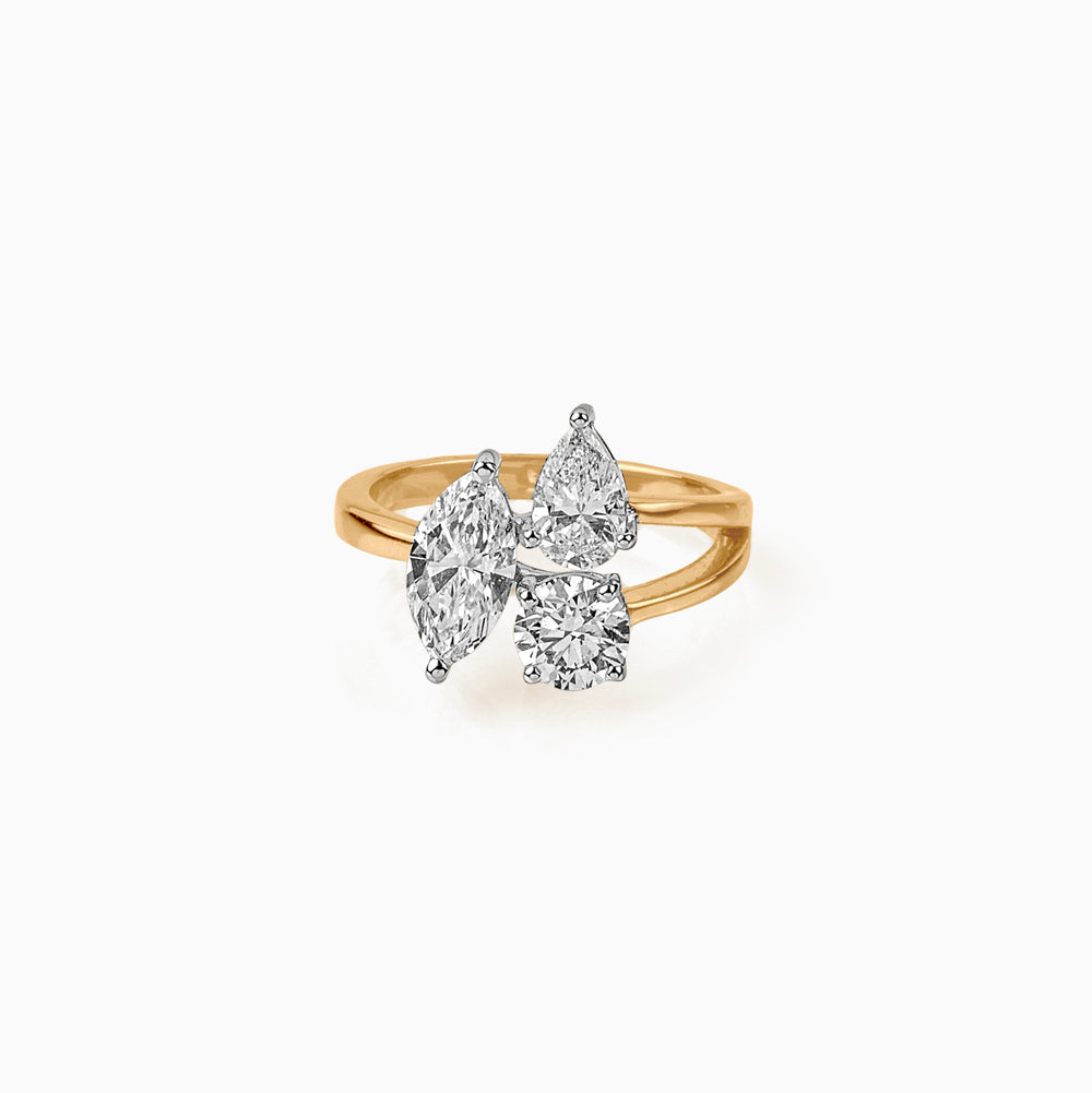 Gold ring with three uniquely cut white diamonds on elegant twisted band
