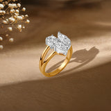Gold ring with diamond cluster on textured background, delicate baby's breath flowers nearby