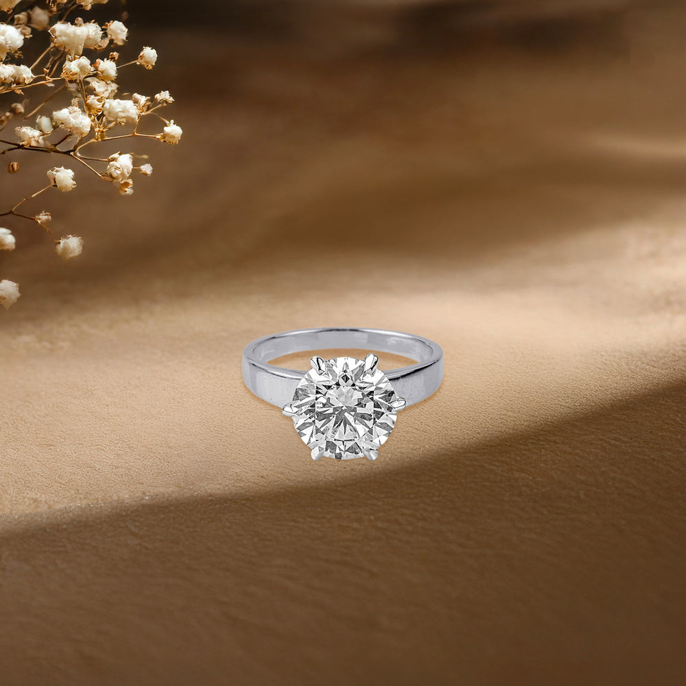 Sparkling solitaire diamond ring on soft beige background with delicate baby's breath flowers