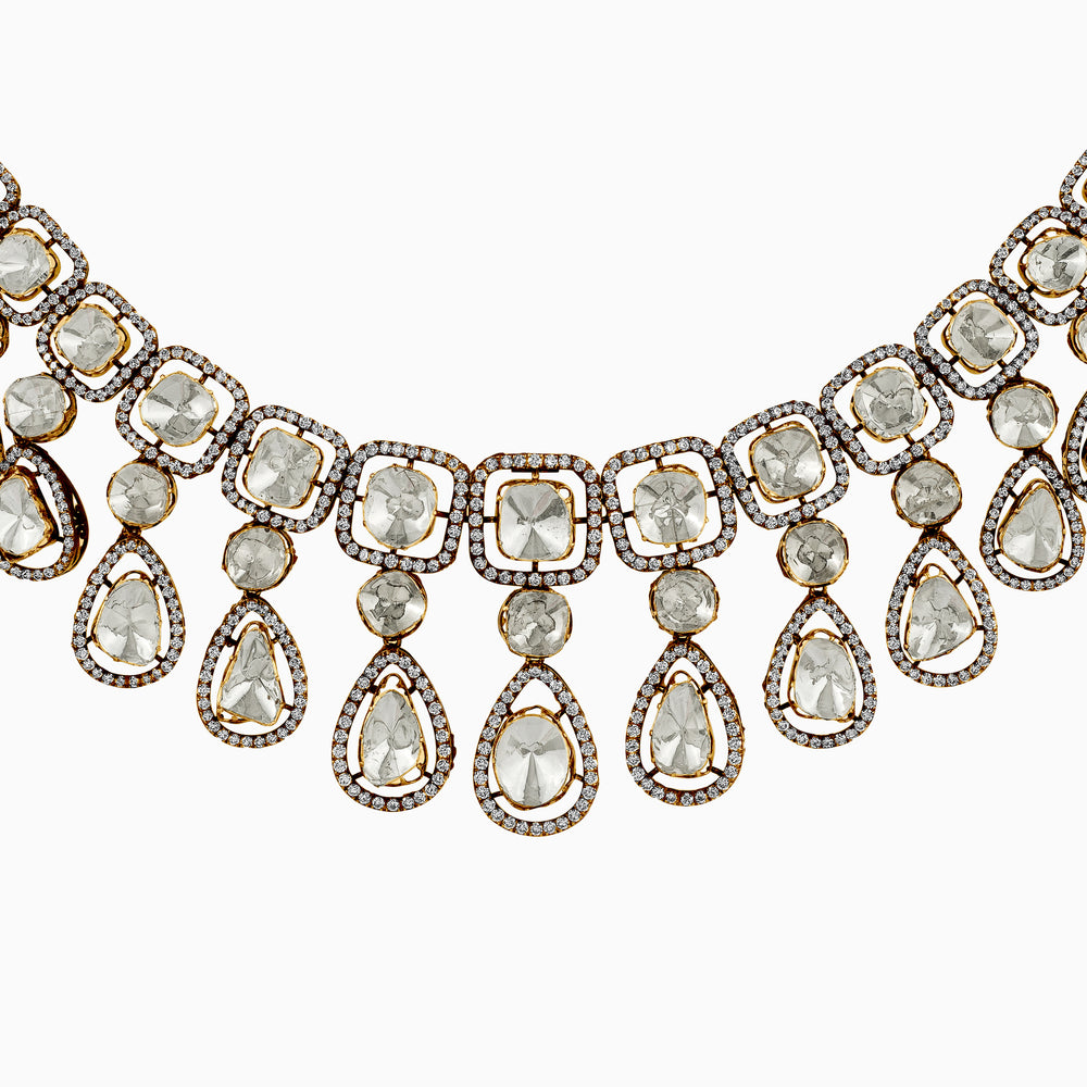 Elegant diamond and gold statement necklace with teardrop and square-cut gems