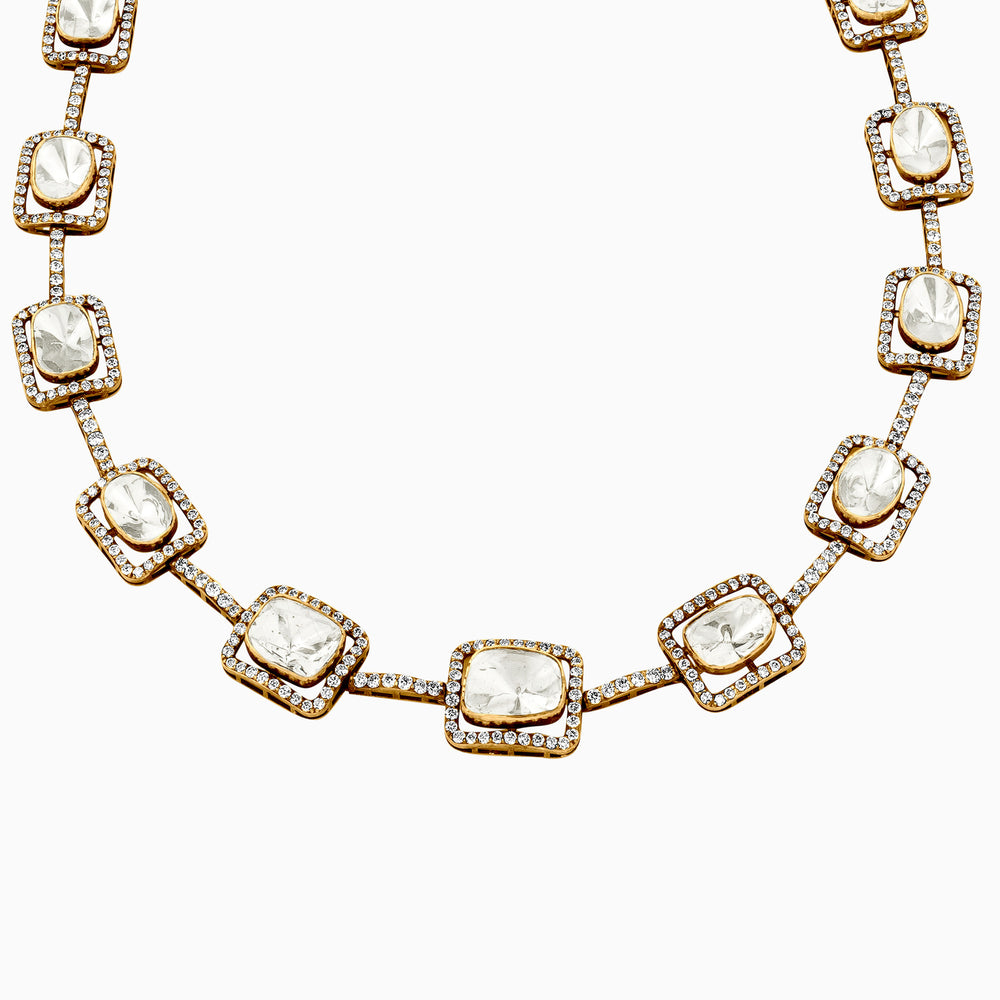 Gold necklace with diamond-studded square pendants and white stone centers