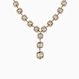 Gold necklace with cushion-cut stones and diamond-rimmed pendant drops