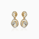 Gold drop earrings with diamond-rimmed translucent gemstones, reflecting elegance and light.