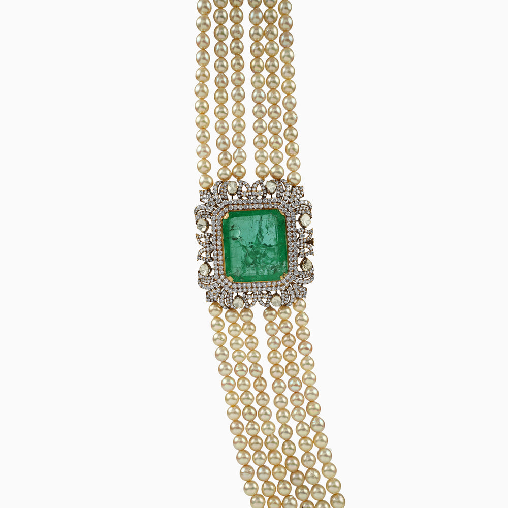 Emerald and diamond pendant on multi-strand pearl necklace, ornate vintage design