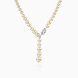 Pearl necklace with marquise diamond clasp, hanging elegantly with soft reflection